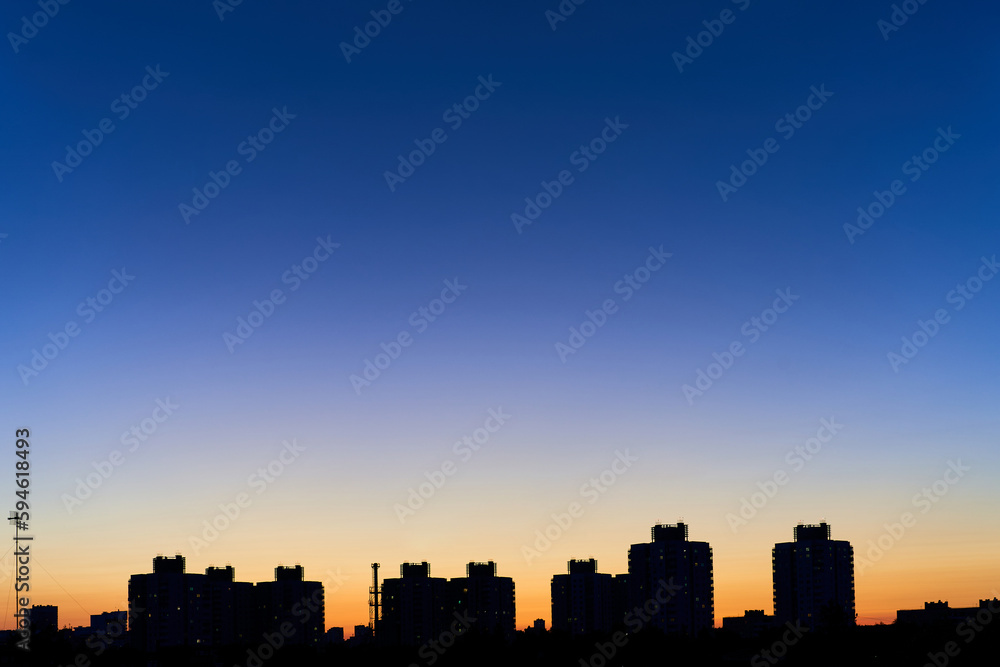 The silhouette of the city against the beautiful sky during sunset. Dense construction of buildings in Minsk