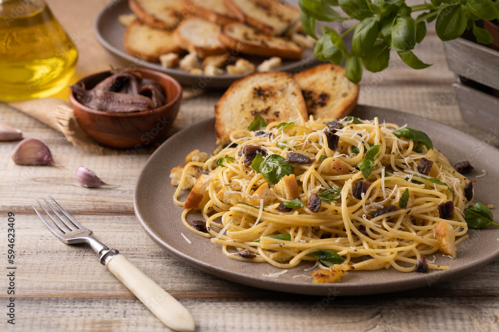 Classic spaghetti with anchovies served with croutons. Classic spaghetti with anchovies served with croutons.