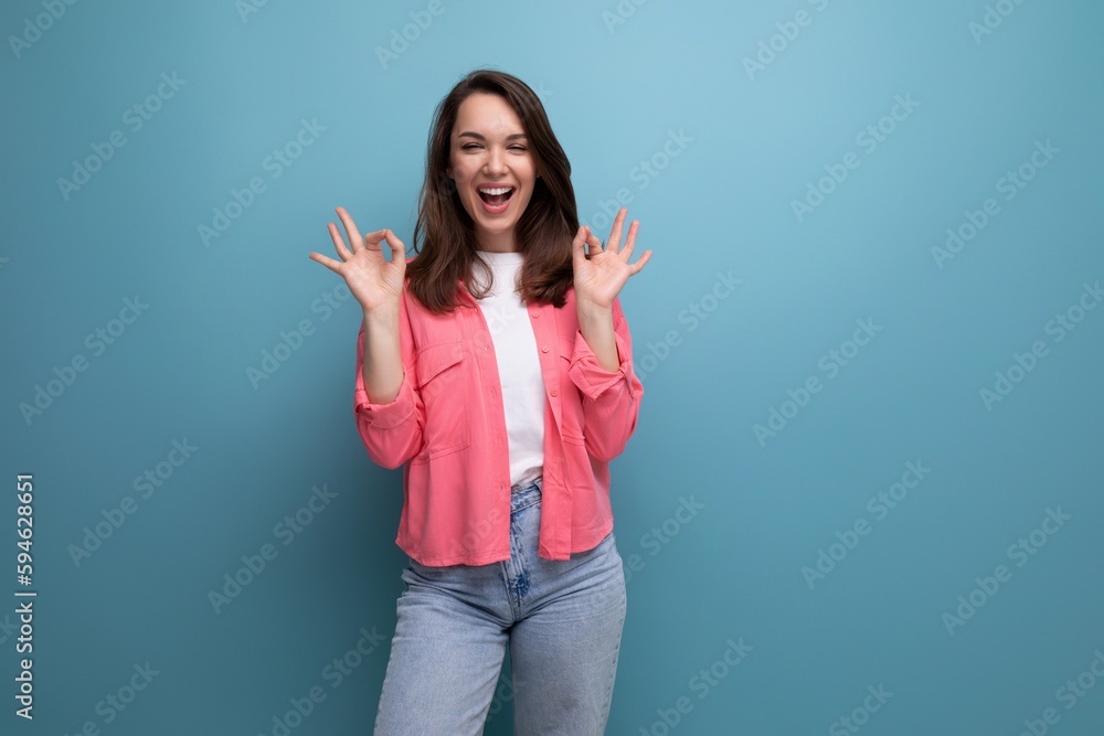 portrait of a woman with dark brown hair in jeans and a tank top with a shirt posing in the studio portrait of a woman with dark brown hair in jeans and a tank top with a shirt posing in the studio