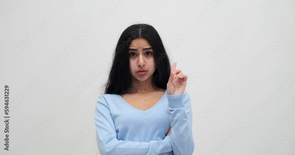 Portrait of shocked woman saying no by shaking her finger and keeping her arms crossed Portrait of shocked woman saying no by shaking her finger and keeping her arms crossed