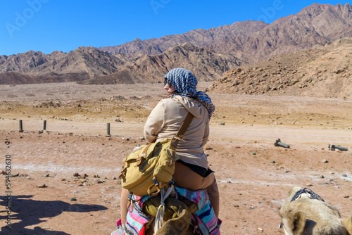Young woman riding camel at the shore of Red sea in Dahab  Egypt