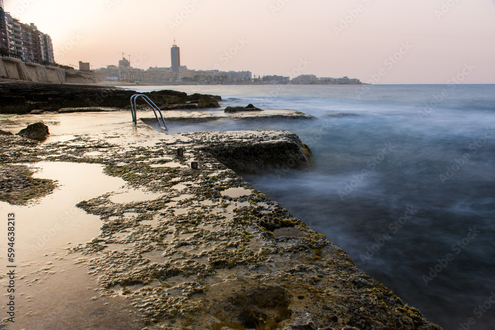 Natural pool in the Mediterranean sea at sunset