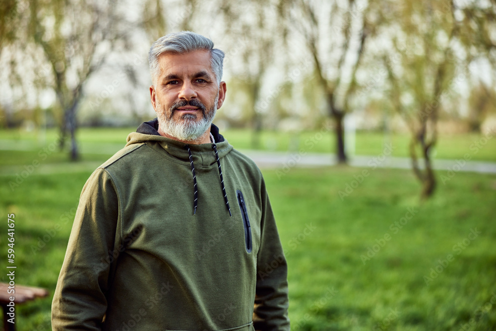 Portrait of a senior man with a greybeard, enjoying himself in nature. Portrait of a senior man with a greybeard, enjoying himself in nature.