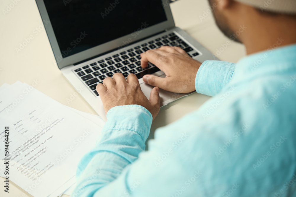 Young male typing on computer at job Young male typing on computer at job