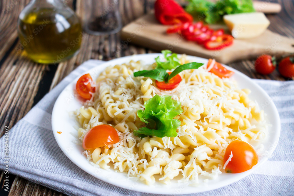 Macaroni with cheese and vegetables. On a wooden background Macaroni with cheese and vegetables. On a wooden background
