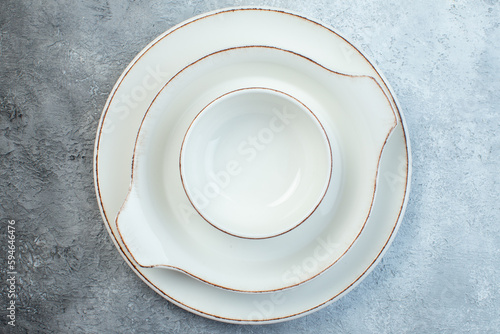 Close up shot of White dinnerware set on half dark light gray background with distressed surface