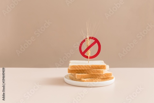 Gluten free bread on beige background with symbol crossed sprinkle. Gluten free concept.