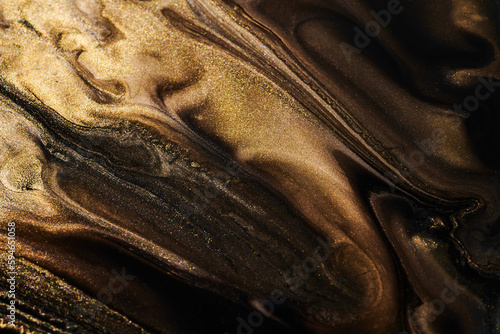 Luxury abstract background, liquid art. Black gold paint mix, alcohol ink blots, marble texture. Modern print pattern