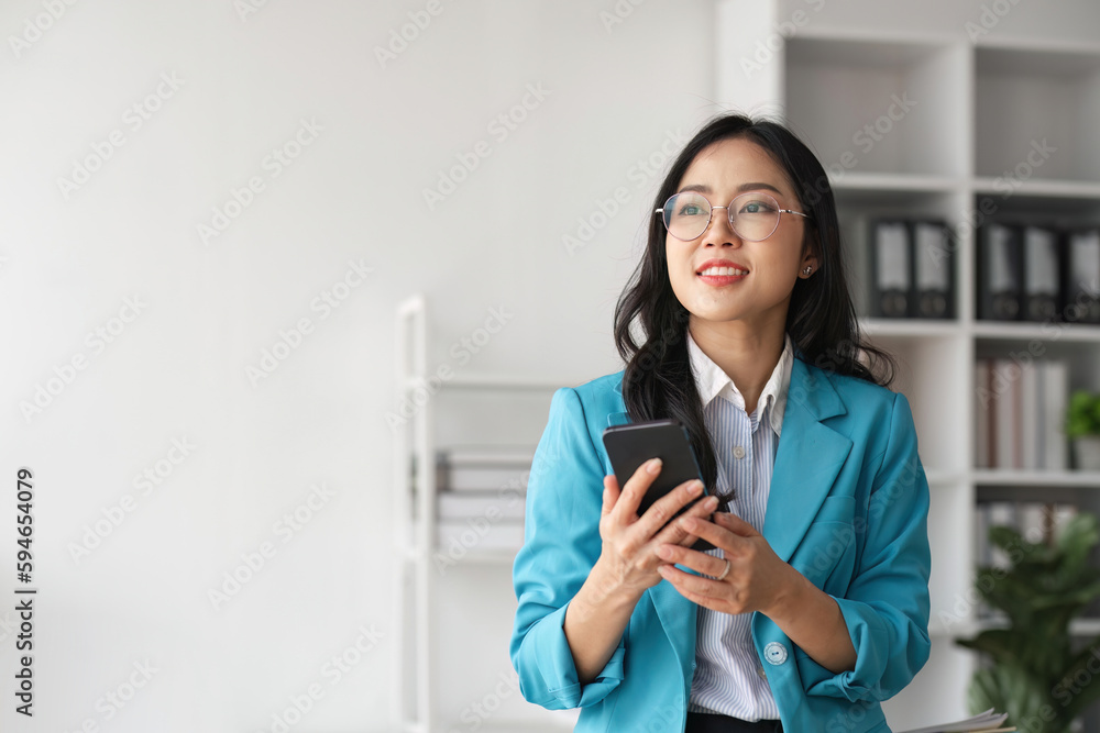 Beautiful Young business Woman Using Smartphone on the office Beautiful Young business Woman Using Smartphone on the office