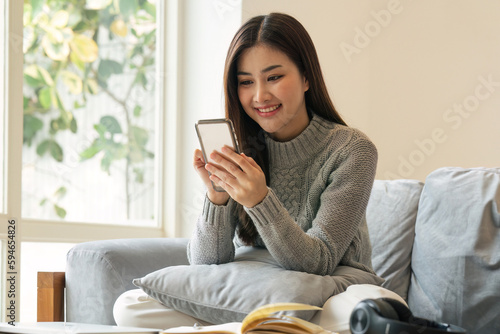 Happy teen girl holding cell phone using smartphone device at home. subscribing new social media, buying in internet, ordering products online in apps