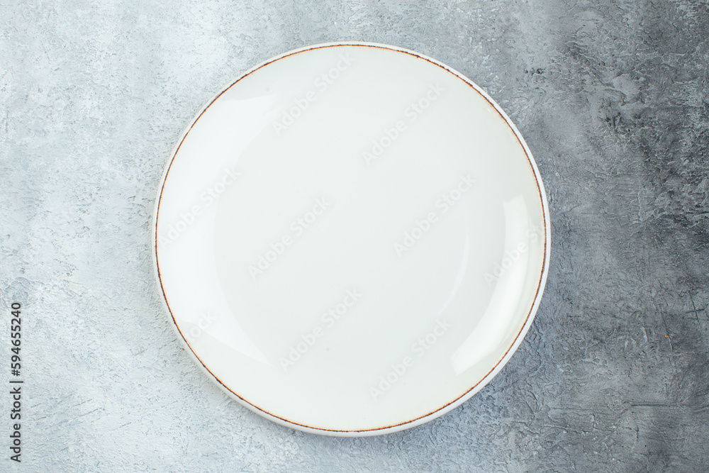 Empty plate on half dark light gray background with distressed coarse-grained gradient surface Empty plate on half dark light gray background with distressed coarse-grained gradient surface