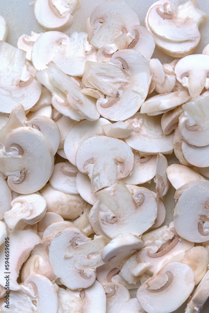Sliced champignon mushrooms close up. Healthy food ingredient concept. Cooking background. Selective focus Sliced champignon mushrooms close up. Healthy food ingredient concept. Cooking background. Selective focus