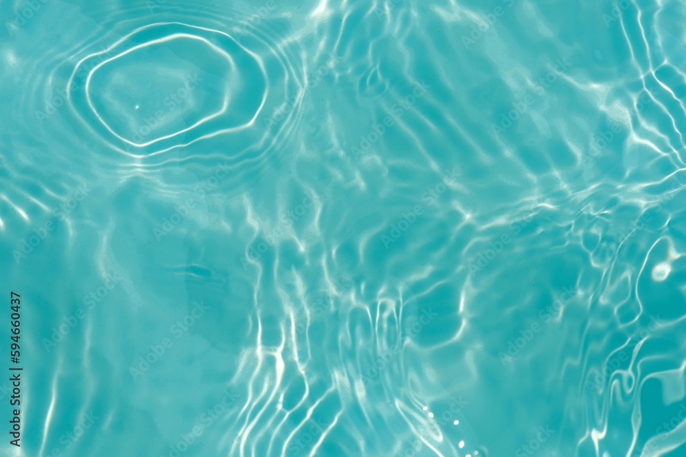 Blue water with ripples on the surface. Defocus blurred transparent blue colored clear calm water surface texture with splashes and bubbles. Water waves with shining pattern texture background texture Blue water with ripples on the surface. Defocus blurred transparent blue colored clear calm water surface texture with splashes and bubbles. Water waves with shining pattern texture background texture