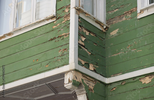 Damaged or weathered wooden house exterior. Needs renovation and repair