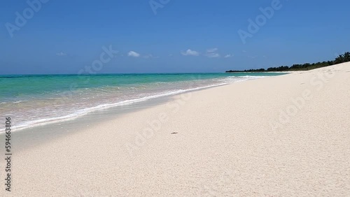 Slow-motion HD footage of sea waves breaking on a white sand beach on a Caribbean island in Mexico. Angle of shot at ground level.