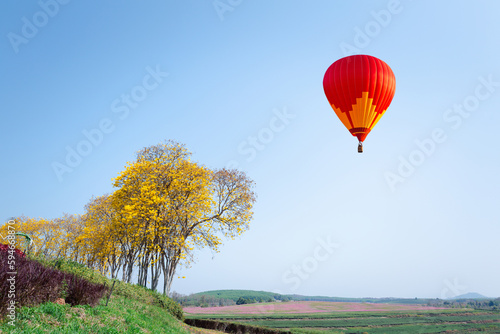 Color hot air balloon flight in the blue sky over the city, and white clouds nature background. transportation concept.