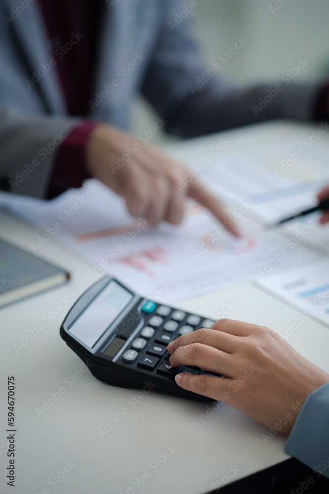 The sales department is having a monthly summary meeting to bring it to the department manager, they are verifying the correctness of the documents that are prepared before bringing in to the manager