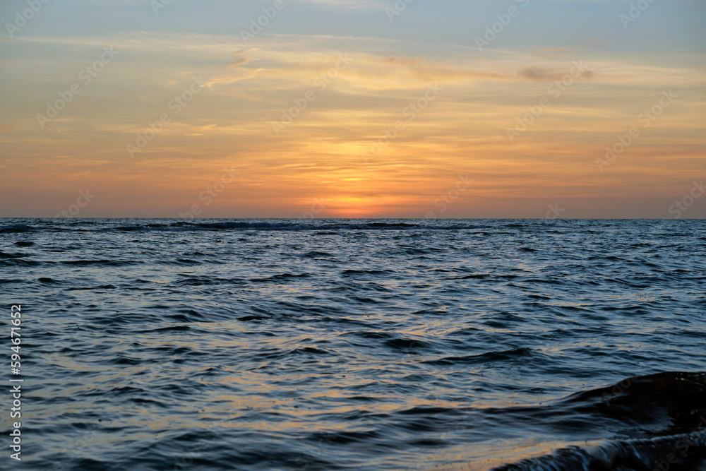 Dramatic red ocean waves at sunset with soft evening sea dark water Dramatic red ocean waves at sunset with soft evening sea dark water