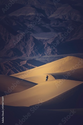 Photographer standing in the desert  looking down at the ground