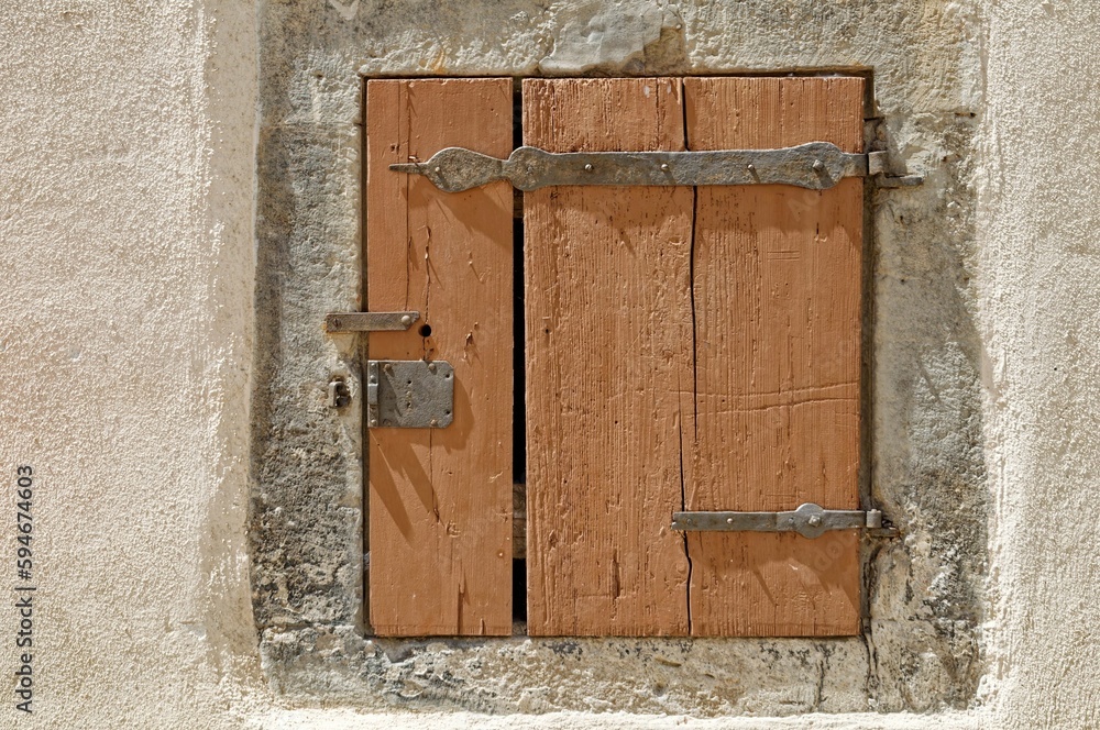 Wooden door of white stone building in countryside with vintage texture