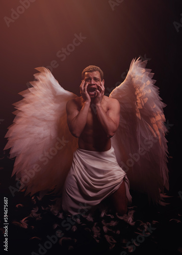 Young strong angel with white wings from heaven. Angel with muscular body. Sensual man