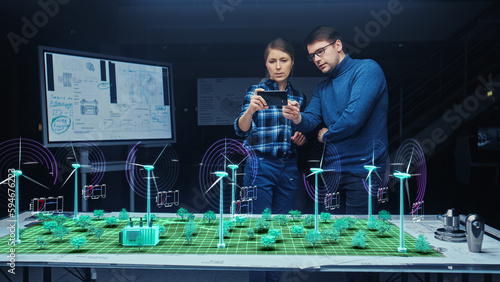 Renewable Energy Engineers Design 3D Wind Turbine Park Using Augmented Reality Software and Smartphone. Specialists Use Virtual Reality App to Work on Green Energy Power Production.
