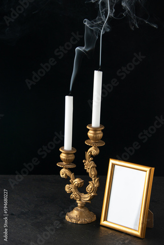 front view of fireless candles with picture frame as memory on a dark background death funeral photo