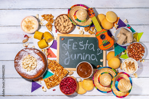 Traditional Festa Junina Summer Festival Carnival Food. Traditional Brazilian Festa Junina dishes and snacks - popcorn, peanuts, corn cake and cookie, pacoca, with holiday decorations and accessories