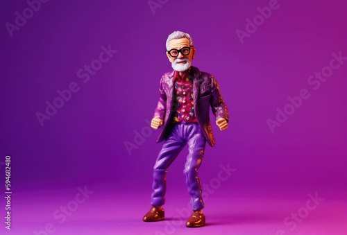 Miniature figure model toy of joyful senior man in party suit dancing happily and carefree at purple
