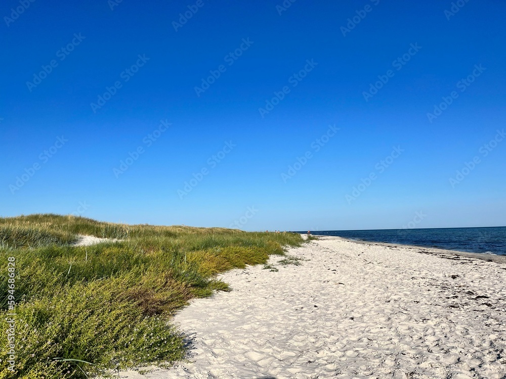 Beautiful, serene landscape shot of the sandy Dueodde beach leading to the sea