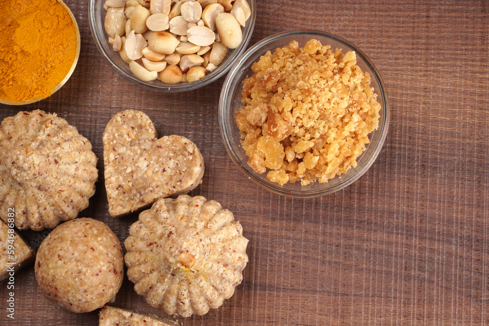 Homemade healthy and sweet groundnut or peanut and Jaggery Laddoo, delicious indian sweet served on a wooden background.Roasted peanut isolated. Homemade healthy and sweet groundnut or peanut and Jaggery Laddoo, delicious indian sweet served on a wooden background.Roasted peanut isolated.