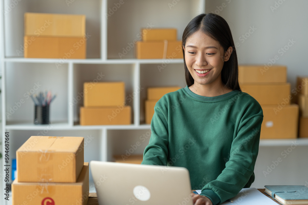 Starting a small business, SME, business owners use laptops to type communications, take orders, and check online purchase orders to prepare packages. Starting a small business, SME, business owners use laptops to type communications, take orders, and check online purchase orders to prepare packages.