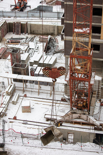 Tower crane on rails at a construction site in winter