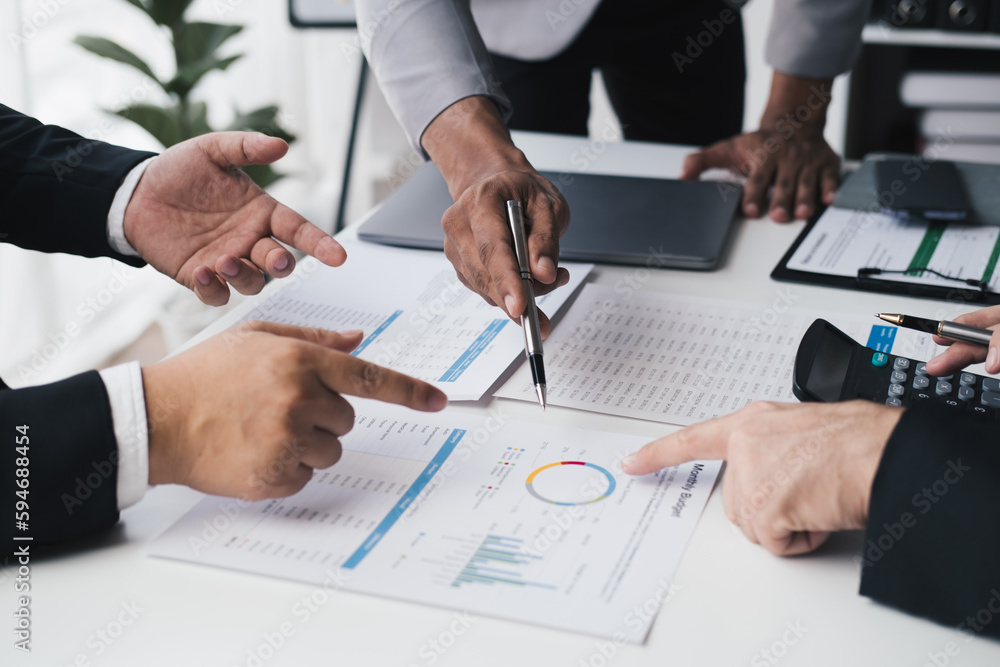 Cropped shot of business people having a discussion about the investment plan together while using graph and document for the project. Cropped shot of business people having a discussion about the investment plan together while using graph and document for the project.