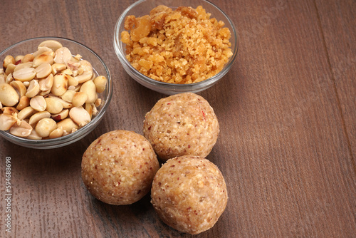 Homemade healthy and sweet groundnut or peanut and Jaggery Laddoo, delicious indian sweet served on a wooden background.Roasted peanut isolated.