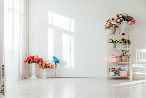 interior of the shelf with flowers in a bright room for the holiday