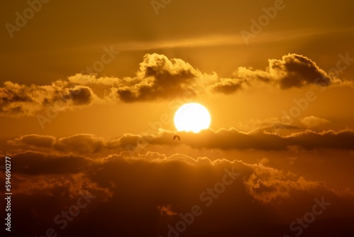 Landscape of a beautiful sunset behind the clouds in the evening - perfect for wallpapers