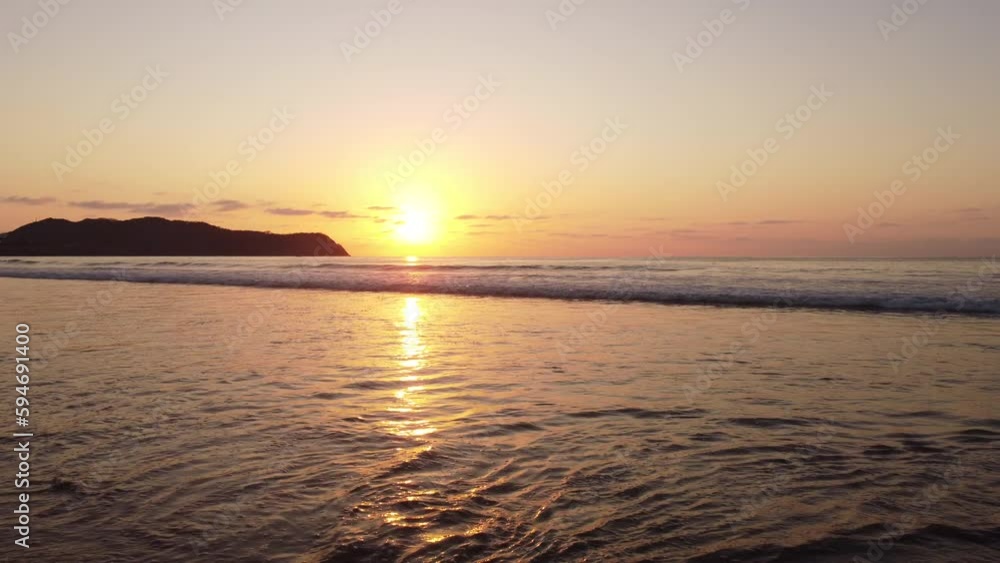 Aerial of the golden sunset shining over the ocean in Punta Mita, Puerto Vallarta Mexico Aerial of the golden sunset shining over the ocean in Punta Mita, Puerto Vallarta Mexico