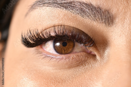a close up of a brown eye with long eyelashes and no makeup