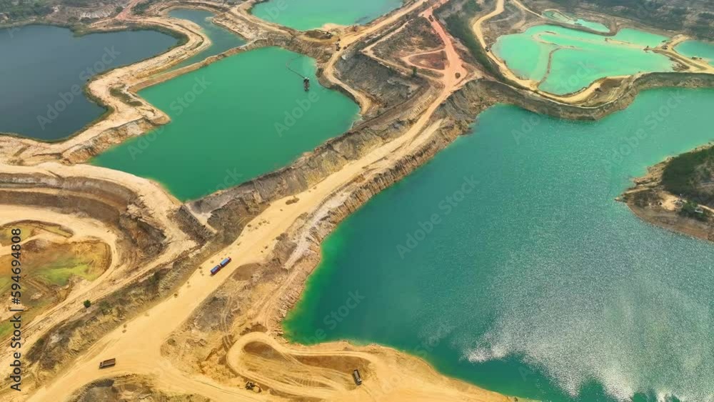 Sand quarries typically appear as large excavated pits in the ground