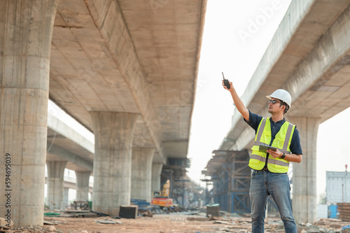 Highway engineering works on construction project planning. Engineer supervising the construction of a concrete bridge at a construction site