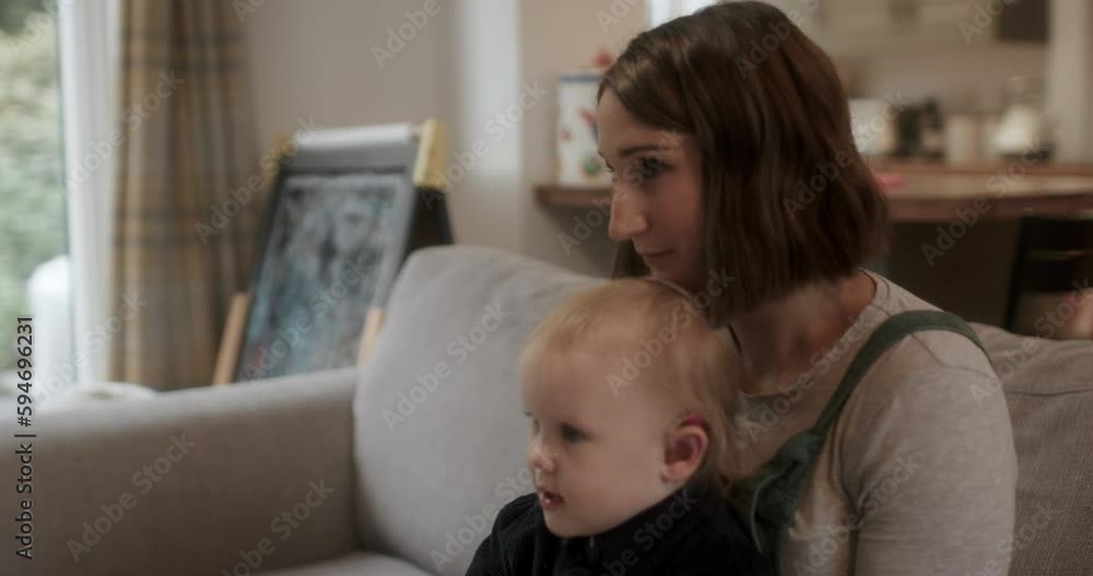 MS Mother and daughter with hearing aid sitting on sofa MS Mother and daughter with hearing aid sitting on sofa