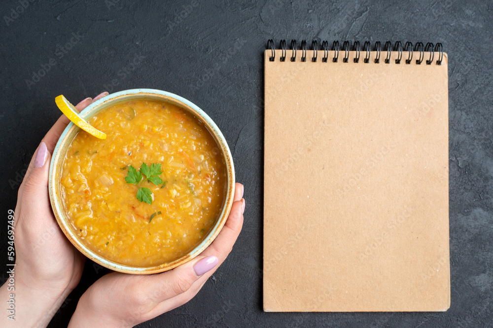 top view delicious lentil soup with female whos holding plate on the dark surface food diner colourful meal dish bread horizontal photo top view delicious lentil soup with female whos holding plate on the dark surface food diner colourful meal dish bread horizontal photo