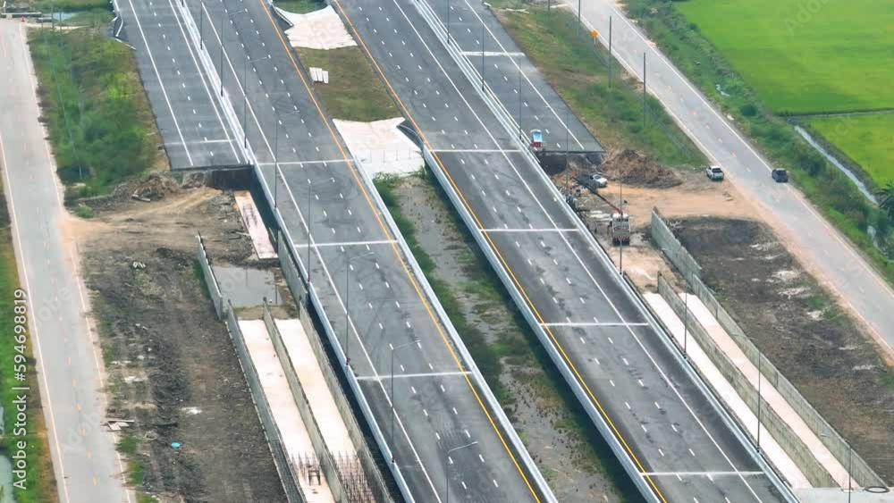 One of the most prominent features of the site is the roadway itself, which may be in various stages of construction, including excavation, grading, paving, and lane striping. Aerial view drone. 4K
One of the most prominent features of the site is the roadway itself, which may be in various stages of construction, including excavation, grading, paving, and lane striping. Aerial view drone. 4K