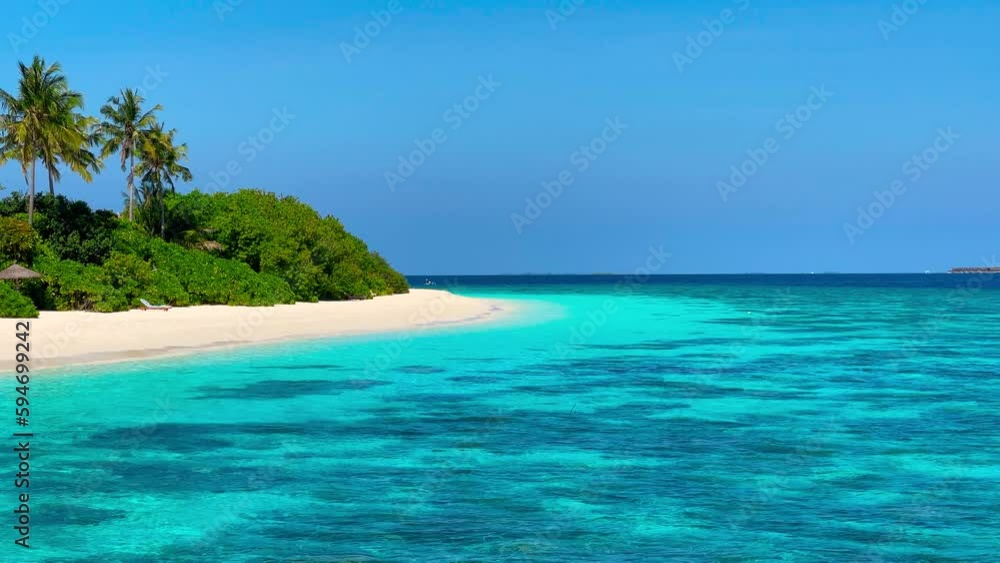 View of the Maldivean coastline from the turquoise sea. View of the Maldivean coastline from the turquoise sea.