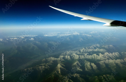 Clouds and sky as seen through window of an aircraft photo