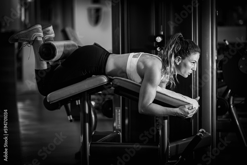 Woman Exercising at Lying Leg Curl Bench