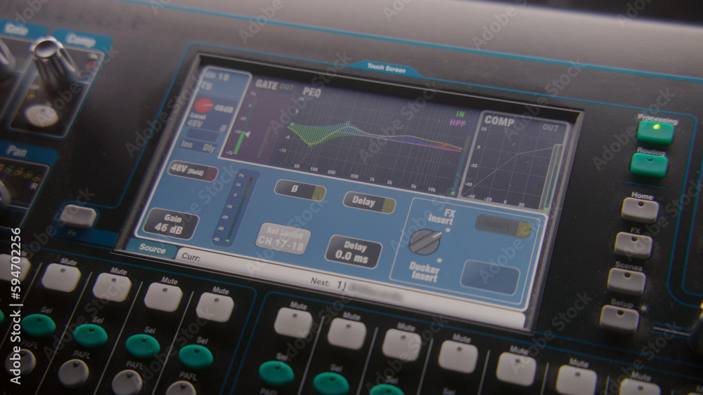 Close up shot of mixing console, remote control for adjusting sound, audio mixer. Small digital touch screen with diagram and sound settings. Modern sound recording studio equipment. Music production. Close up shot of mixing console, remote control for adjusting sound, audio mixer. Small digital touch screen with diagram and sound settings. Modern sound recording studio equipment. Music production.