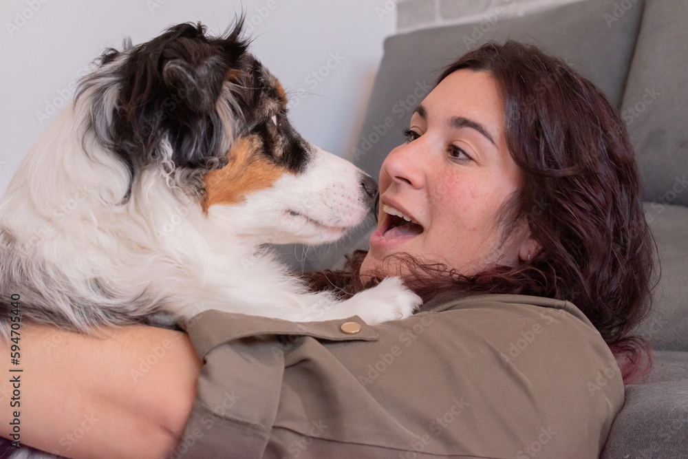 Young woman with a shocked face hugging her dog. Young woman with a shocked face hugging her dog.