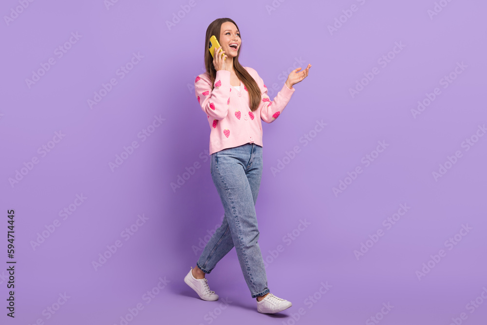 Full length photo of adorable sweet girl wear berry print cardigan communicating modern device isolated violet color background Full length photo of adorable sweet girl wear berry print cardigan communicating modern device isolated violet color background